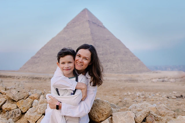Mother & son in front of the Pyramids of Giza in Egypt