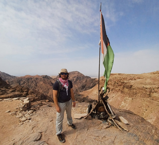 Sam by the flag of Jordan near Petra in Jordan.