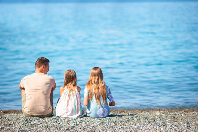 Family sat on the beach in Oman