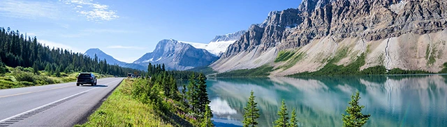 Scenic view of a car driving down the road near Banff in Canada