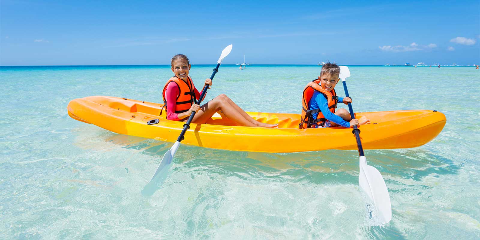 Children sea kayaking on a family holiday