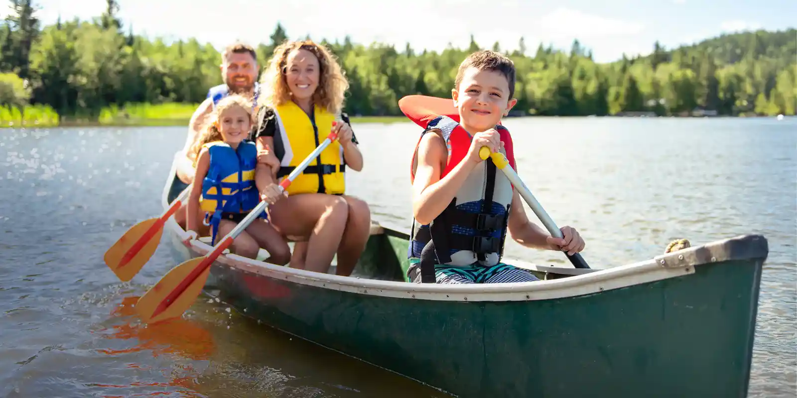 Family on holiday river kayaking