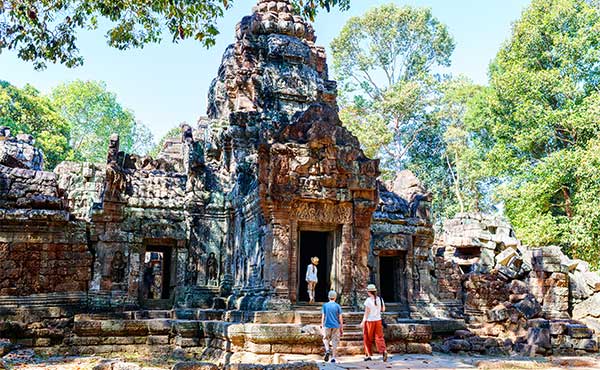 Family exploring Ta Som temple in Angkor Wat, Siem Reap, Cambodia