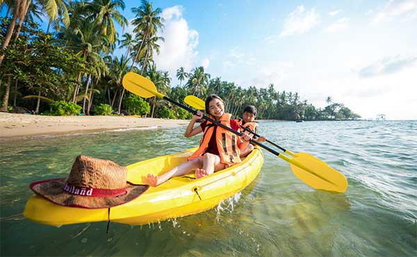 Siblings kayaking in Phuket, Thailand