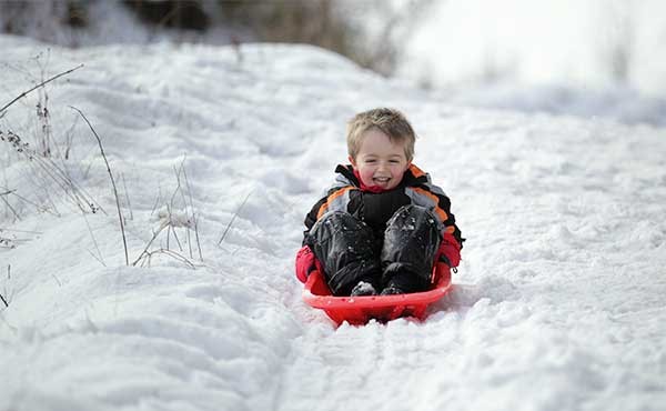 Boy sledging in Finland