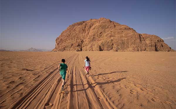 Children running in Wadi Rum, Jordan